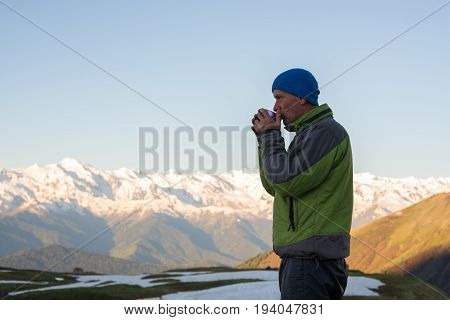 Meditative Traveler Drinking Coffee And Watching A Sunrise