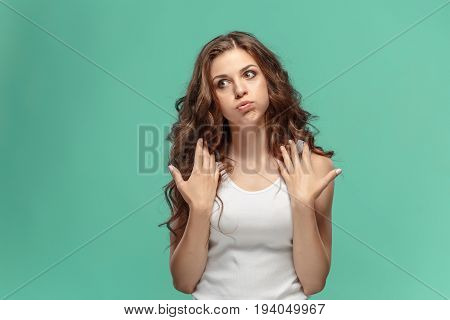Portrait of an angry woman looking away on a blue background