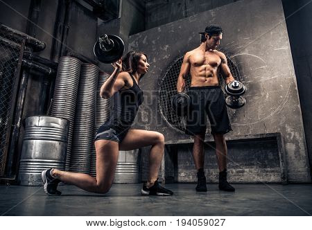 Athletes training with weights in a gym - Functional training workout