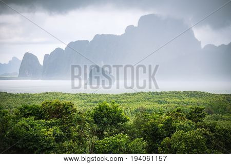 Cloudy sky and fog after raining cover island near green beach called 'Samet Nangshe' which is attractive place in Phang Nga of Thailand.