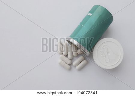 Pills spilling out of pill bottle. Top view with copy space. Medicine concept