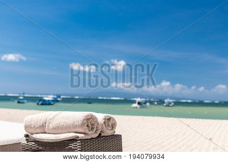 Cream beach towel on the ocean background. Tropical Bali island.