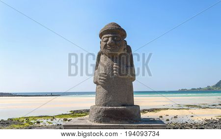 Dol hareubang statue on the beach at Jeju island symbol of Jeju island