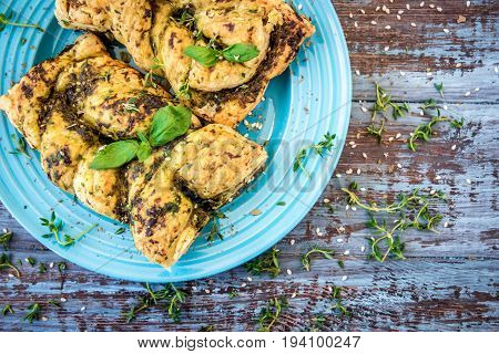 Tarte with pesto basil. New Year pastry: pesto sun pie and fir branch.
