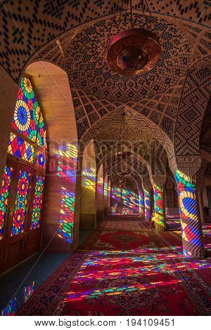 SHIRAZ IRAN - OCTOBER 23 2016 : Colorful light through stained glass window inside Nasir Al-Mulk Mosque (Pink Mosque) a traditional mosque in Shiraz Iran.