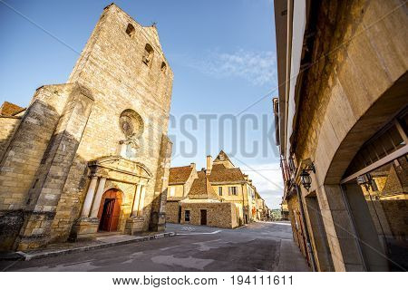 Sunset view on the old church and town hall in Domme village in France