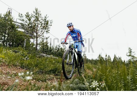 Revda Russia - July 1 2017: athlete disabled amputee no arms on bicycles during Regional competitions on mountain bike
