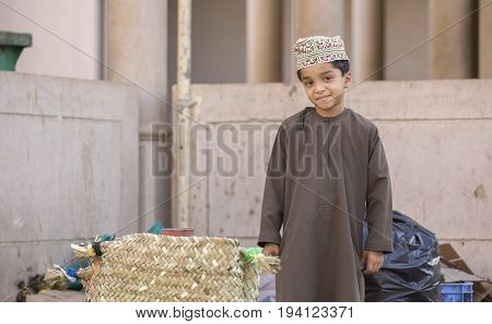 Nizwa Oman June 23rd 2017: omani boy in traditional clothing at a market