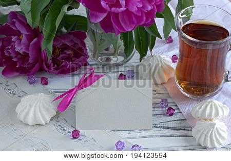 Peonies Flowers Pink Glass Of Tea With Greeting Card Marshmallow On A White Wooden Background - Stoc