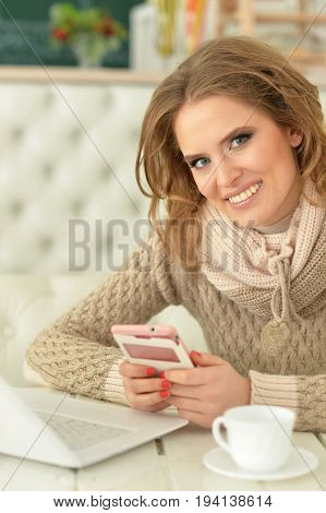 Portrait of a young beautiful woman using smartphone