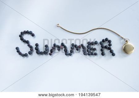 Summer time spelt with blueberries and a pocket watch