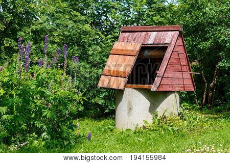 Rustic Wooden Water Well With An Open Door