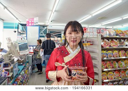 SEOUL, SOUTH KOREA - CIRCA MAY, 2017: woman at GS25 convenience store in Seoul. GS25 is a convenience store brand in South Korea.