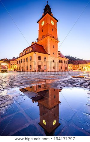 Brasov Transylvania Romania - Twilight image with water reflection of Council House medieval downtown.