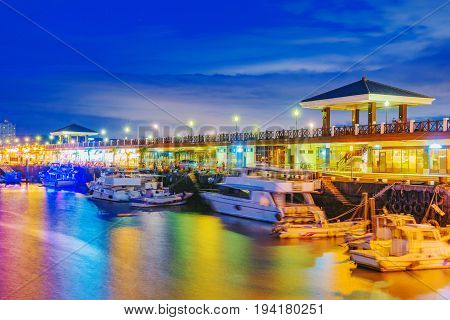 View of Tamsui pier with boats at night
