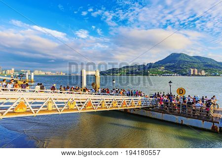 TAIPEI TAIWAN - MAY 29: Tourist's waiting on a pier for a tourboat which wiill take them to Fisherman's wharf a famous landmark in Tamsui on May 29 2017 in Taipei