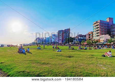 TAIPEI TAIWAN - MAY 29: View of Tamsui riverside park area where people come to sit relax and have picnic in the summer time and look at the river views on May 29 2017 in Taipei