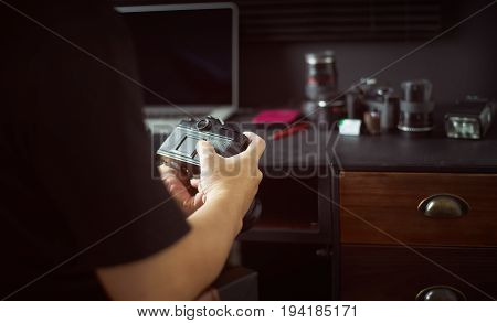 Photographer working checking camera Stylish home studio concept of hipster . Seleted focus.