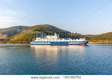 Grimaldi Group eurocargo ship cruising at sunset in Corfu, Greece