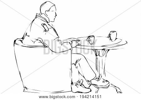 Man In A Chair Drinking Tea In A Cafe