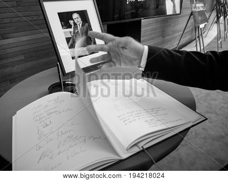 STRASBOURG FRANCE - JUL 1 2017: The messages in diverse languages of high ranked officials on the book of condolences next to a portrait of late former German Chancellor Helmut Kohl at European Parliament. Kohl who was Christ democrat or CDU party member