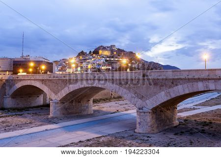 Historic stone bridge over the Guadalentin river in Lorca illuminated at night. Province of Murcia southern Spain