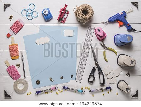 Top View Of Blue Pages And Layout Tools For Needlework And Scrapbooking On Wooden Boards With Copy S
