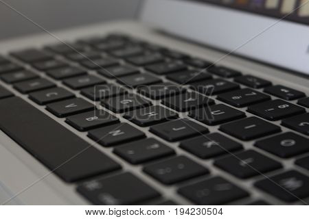 Laptop keyboard from another side, with a blur