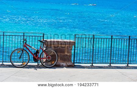 Mountain bike by the sea in Alghero seafront. Sardinia Italy