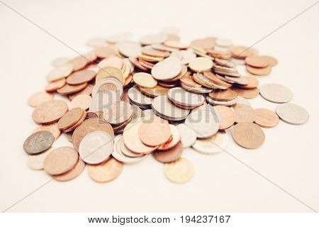 Close-up of large group of coins over white background