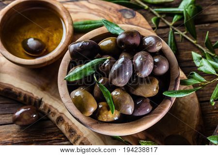 Olives And Olive Oil In Olive Wooden Bowls, Olive Tree Branch