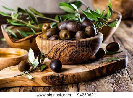 Olives And Olive Oil In Olive Wooden Bowls, Olive Tree Branch