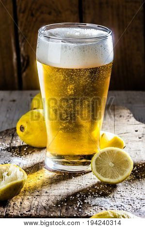Ingredients for mexican chilean beer drink - Michelada. Beer, salt, lemon