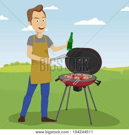 Handsome young man cooking barbecue grill outdoors holding a bottle and tongs
