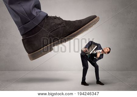 Young businessman illustrated inconsiderable by being trampled