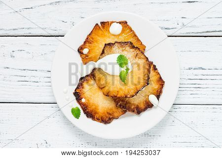 Fried Pineapple Slices With Creme Fraiche, White Table. Top View