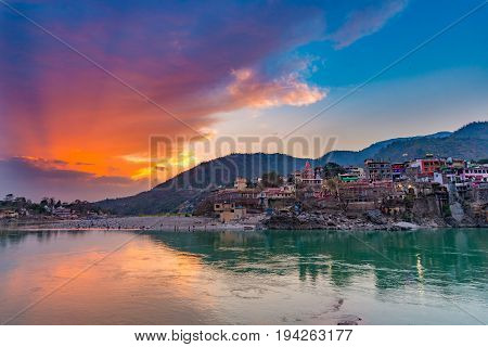Dusk Time At Rishikesh, Holy Town And Travel Destination In India. Colorful Sky And Clouds Reflectin