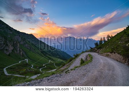 Dirt Mountain Road Leading To High Mountain Pass In Italy (colle Delle Finestre). Expasive View At S
