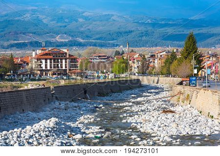 Bansko, Bulgaria - April 14, 201: Spring view with river Glazne, mountains landscape and houses in all season resort Bansko