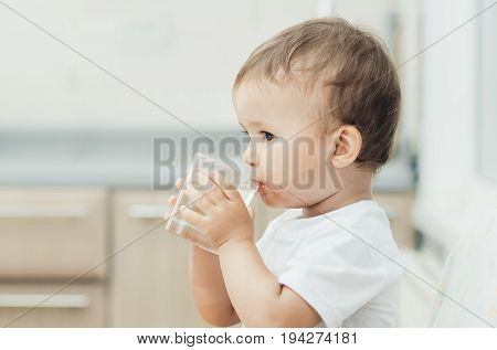 A Boy Drinks Water In The Kitchen