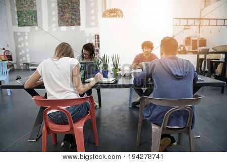 Trendy young people working in co-working office 