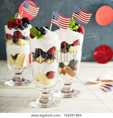 Layered dessert parfait with sweet bread, whipped cream and berries for 4th of July