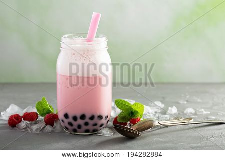 Strawberry bubble tea in mason jar with thick straw
