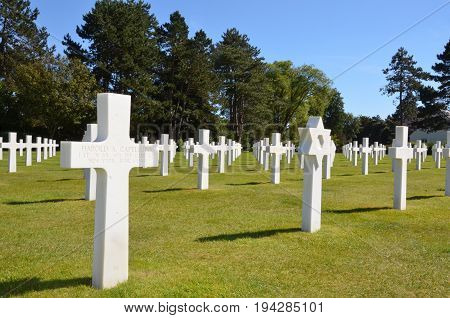 COLLEVILLE-SUR-MER FRANCE - AUG 12: Tombstones at the Normandy American Cemetery and Memorial in Colleville-Sur-Mer France are shown on August 12 2016.