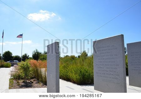 COLLEVILLE-SUR-MER FRANCE - AUG 12: A Franklin Roosevelt quote at the Normandy American Cemetery and Memorial in Colleville-Sur-Mer France is shown on August 12 2016.