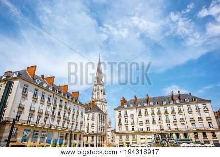 View on the Royal square with fountain and church tower in Nantes city in France
