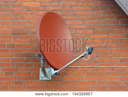 image of satellite dish on a brick wall