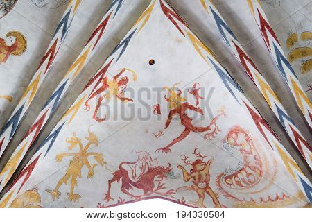 Devils in front of the jaws of hell gothic fresco in Vinderslev church Denmark June 22 2017