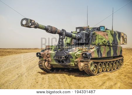 an american howitzer stands on a battlefield