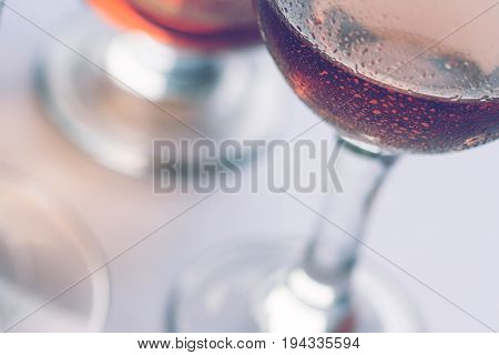 closeup of rose wine glasses of different shapes and sizes with selective focus